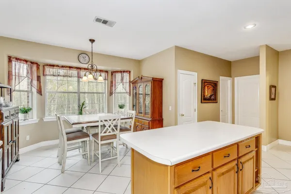 a kitchen with a table and chairs in it