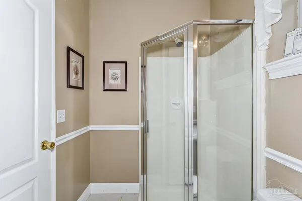 a bathroom with a glass shower door