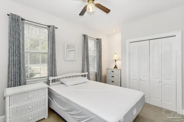 a spacious bedroom with a bed and a chandelier