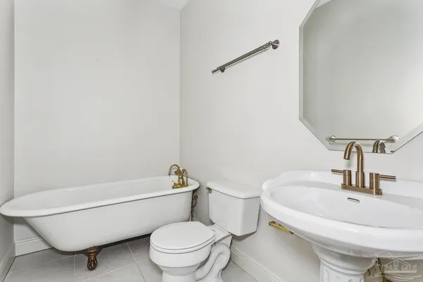 a white toilet sitting next to a bathroom sink