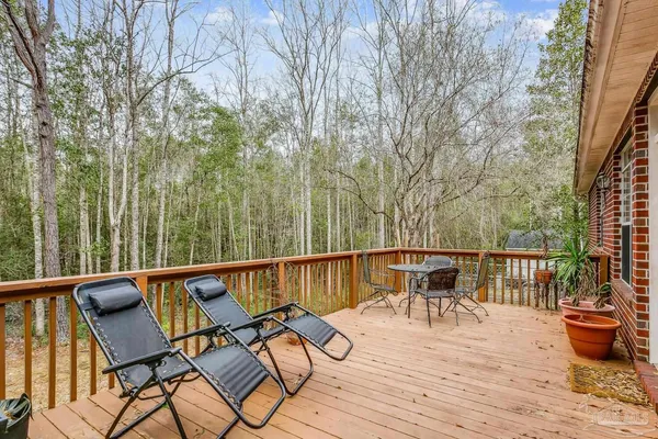 a view of a patio with furniture and wooden floor