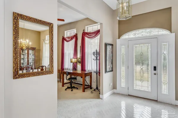 a view of a hallway with dining area and glass door