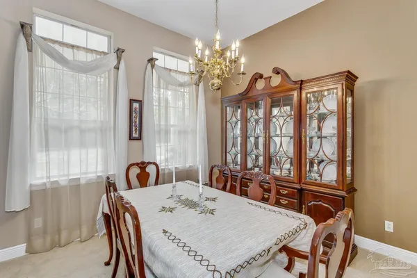 a view of a dining room with furniture and window