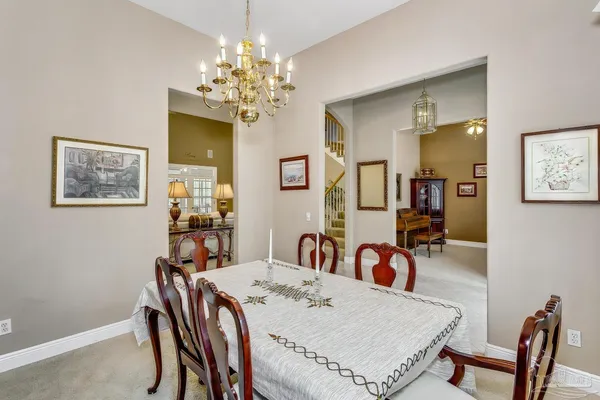 a view of a dining room with furniture and chandelier
