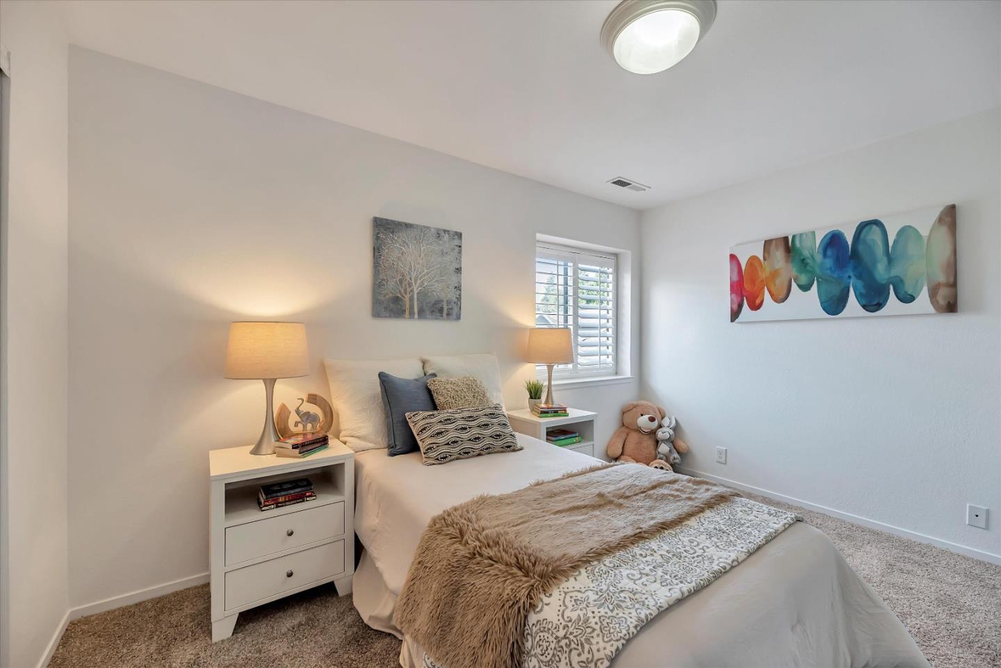 17075 Creekside Circle Morgan Hill, CA 95037 - Photo 18 of 49 a bedroom with a bed and a painting on the wall