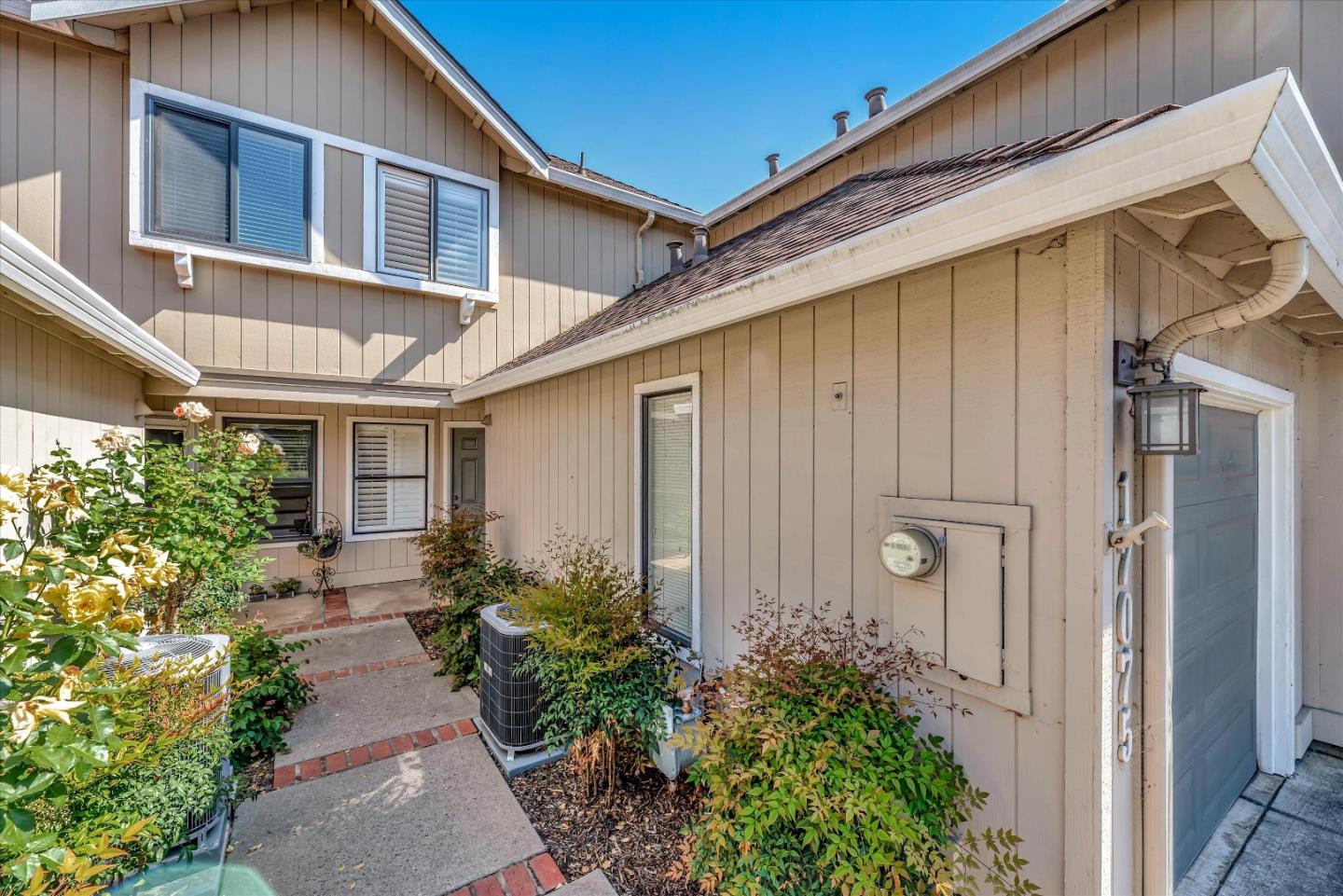 17075 Creekside Circle Morgan Hill, CA 95037 - Photo 2 of 49 a backyard of a house with flower plants