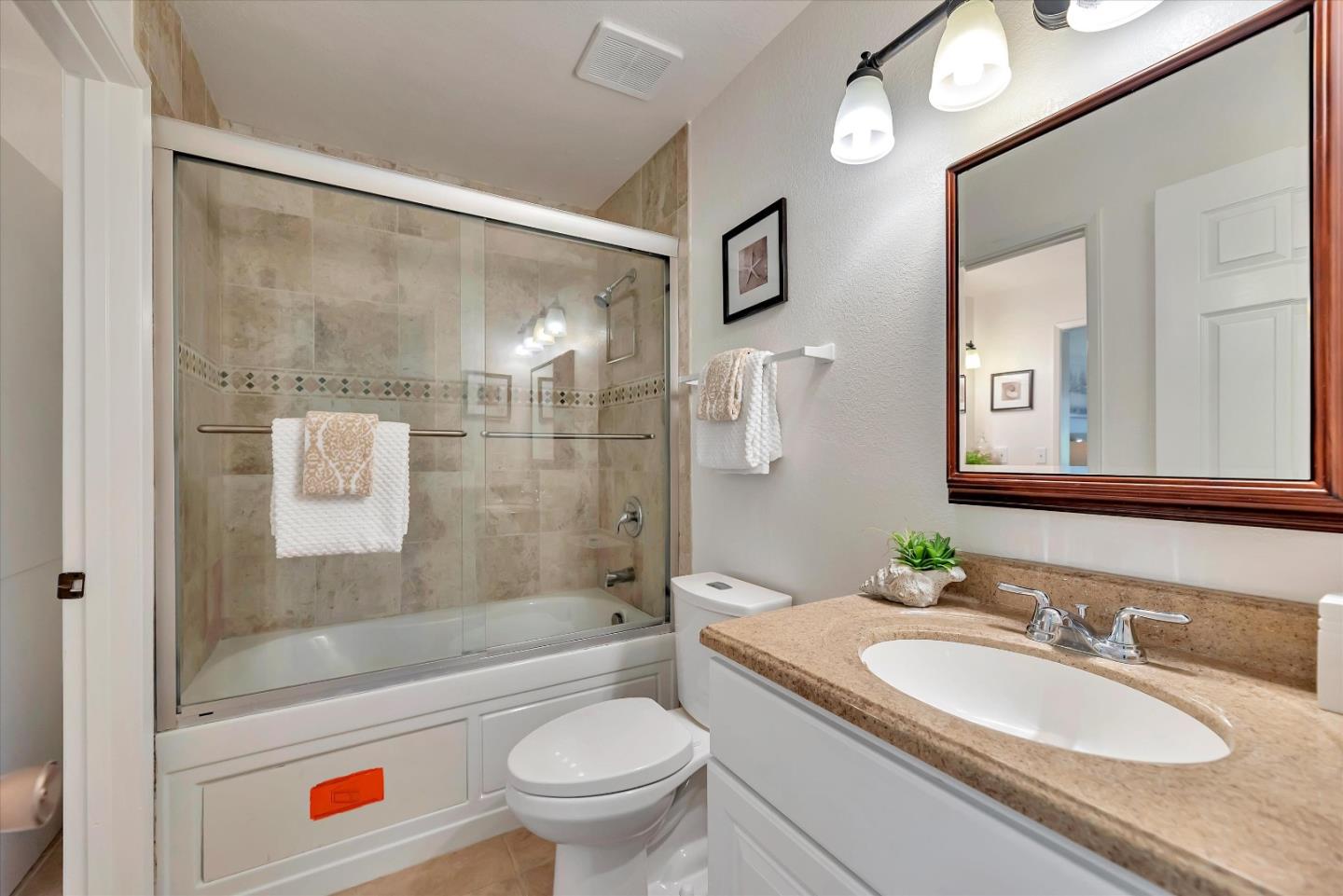 17075 Creekside Circle Morgan Hill, CA 95037 - Photo 24 of 49 a bathroom with a granite countertop sink toilet mirror and shower