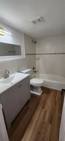 a bathroom with a double vanity sink a toilet and a mirror