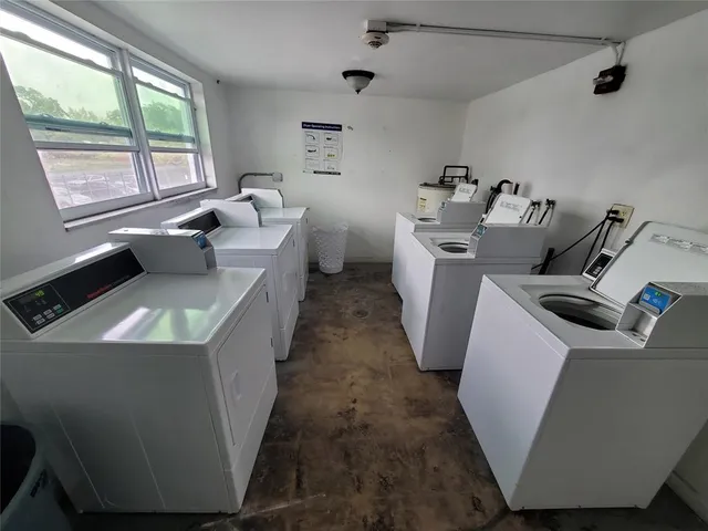 a utility room with faucet washer and dryer
