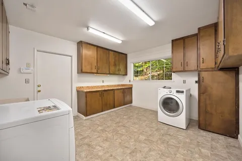 an empty room with a window and a ceiling fan