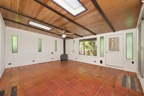 a view of a room with wooden floor and a ceiling fan