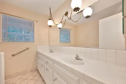 a view of a house with backyard and sitting area