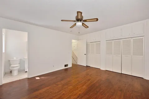 a backyard of a house with trees and outdoor seating