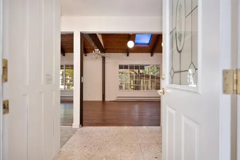 a view of empty room with wooden floor