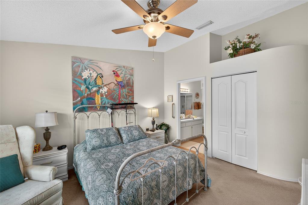 2292 Austrian Lane, Unit 26 Clearwater, FL 33763 - Photo 12 of 27 a bed room with a bed and a painting on the wall