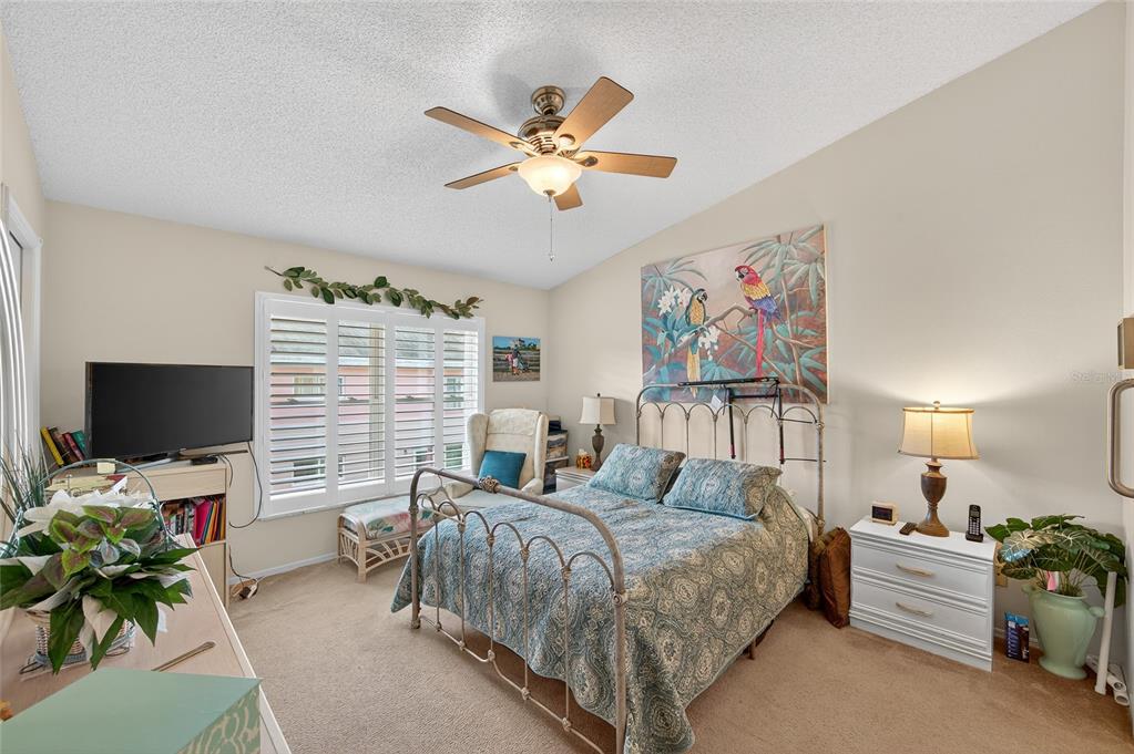 2292 Austrian Lane, Unit 26 Clearwater, FL 33763 - Photo 14 of 27 a bedroom with furniture and a flat screen tv