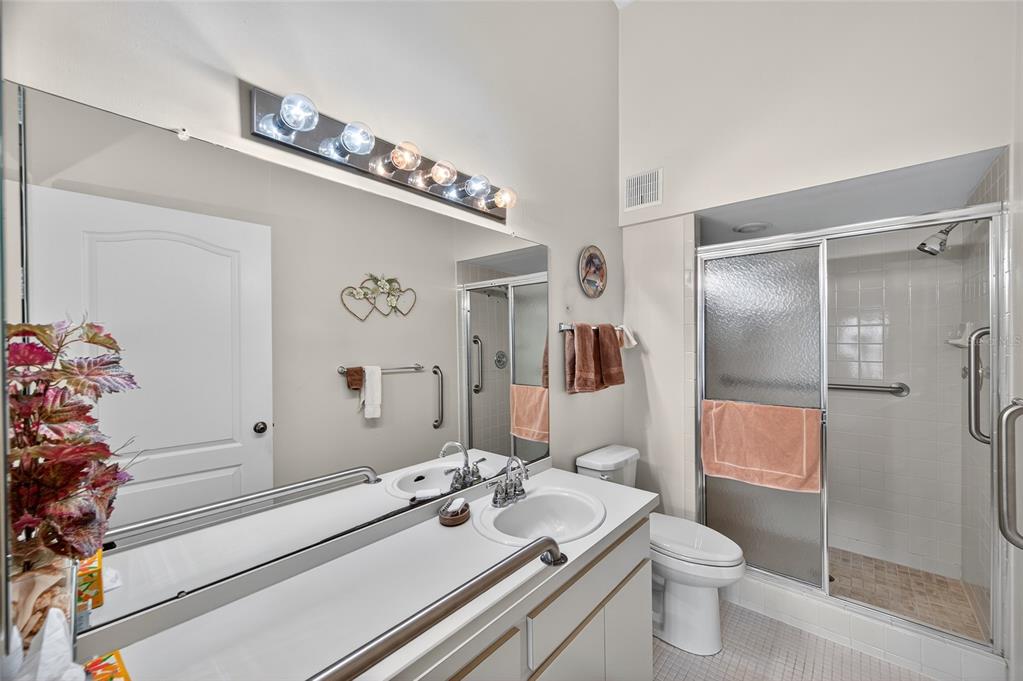 2292 Austrian Lane, Unit 26 Clearwater, FL 33763 - Photo 15 of 27 a bathroom with a sink a toilet and shower