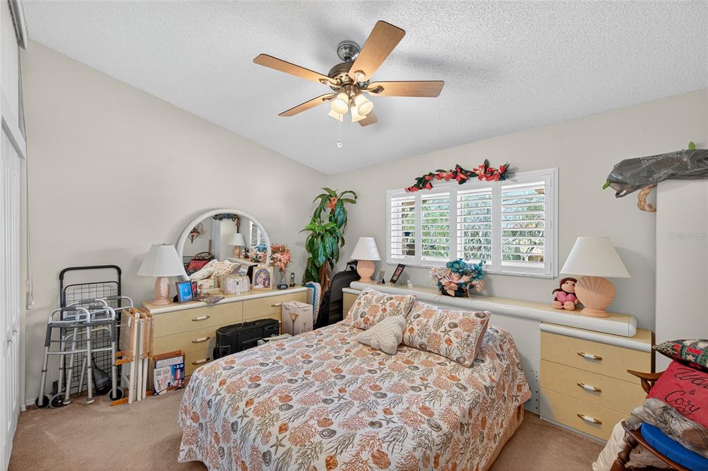 2292 Austrian Lane, Unit 26 Clearwater, FL 33763 - Photo 16 of 27 a bedroom with a bed and a large window