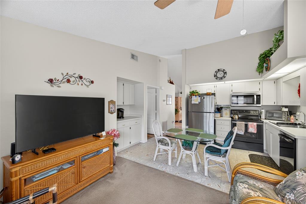 2292 Austrian Lane, Unit 26 Clearwater, FL 33763 - Photo 7 of 27 a living room with furniture and a flat screen tv