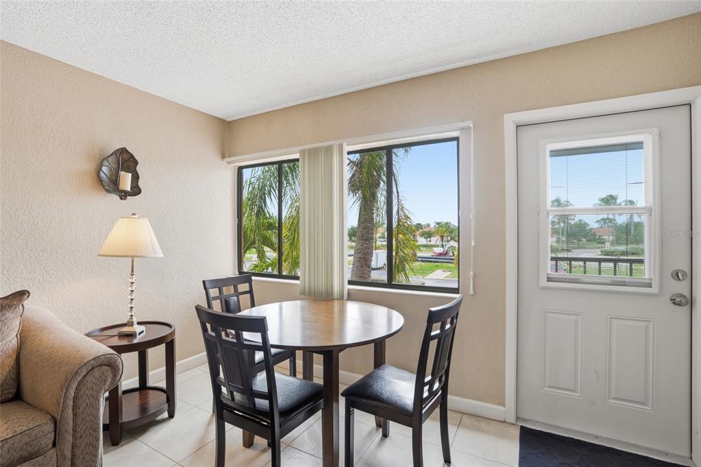 3170 Matecumbe Key Road, Unit 127 Punta Gorda, FL 33955 - Photo 9 of 22 a view of a dining room with furniture window and outside view