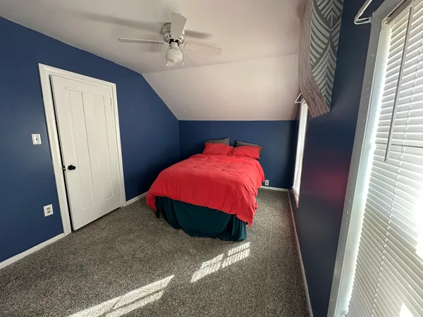 a bed room with a bed and a window