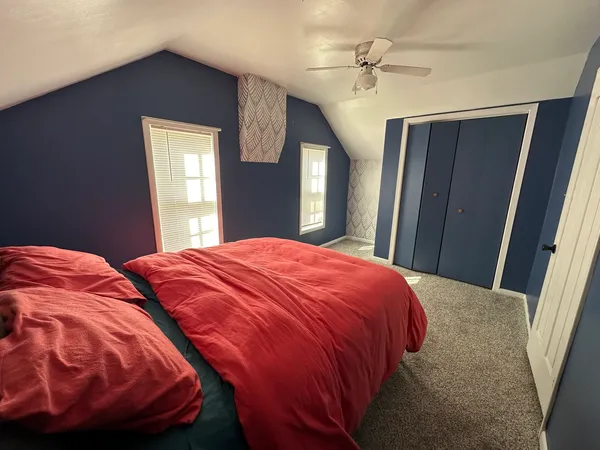 a bedroom with a bed and a chandelier