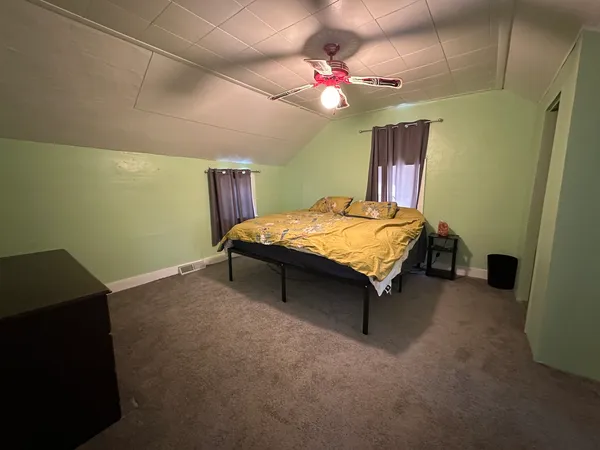 a bed room with a bed and a chandelier