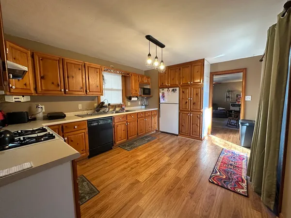 a kitchen with refrigerator and cabinets