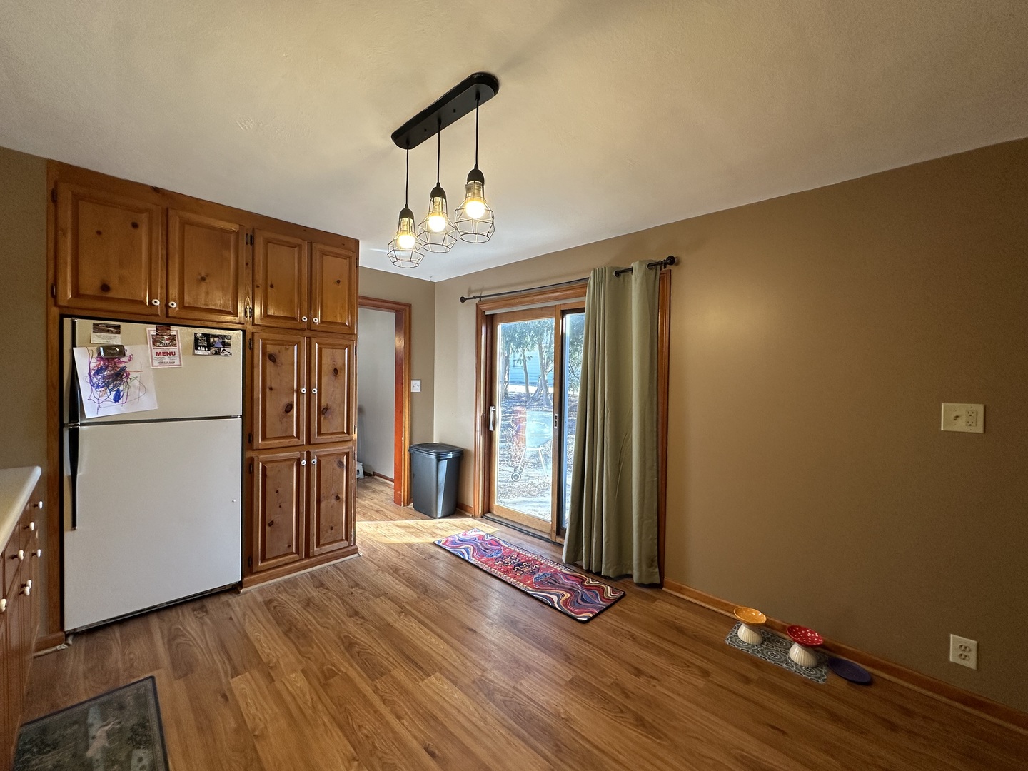 624 West Lincolnway Road Morrison, IL 61270 - Photo 10 of 26 a view of a room with wooden floor and a refrigerator