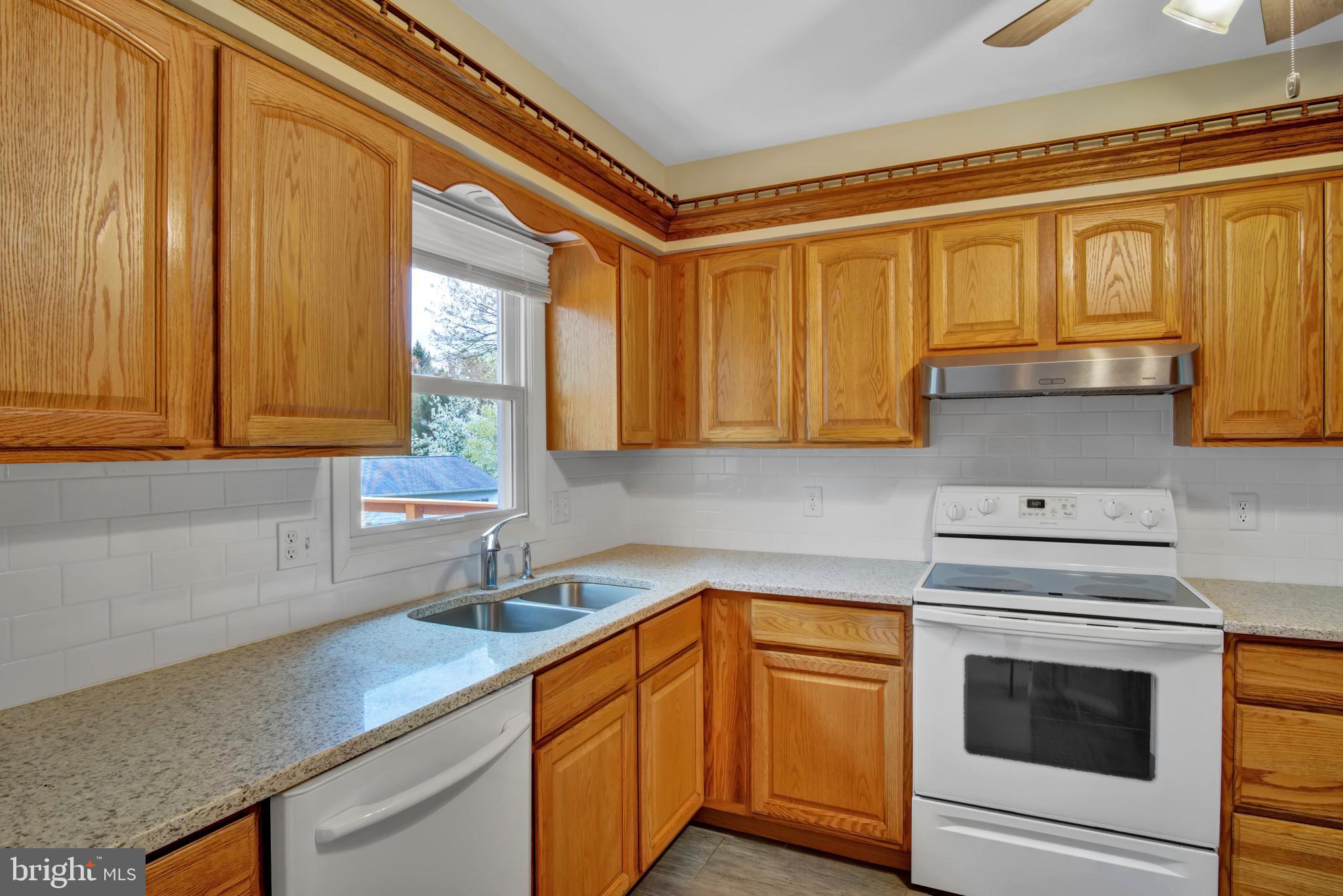 45 Sam Snead Circle Etters, PA 17319 - Photo 11 of 34 a kitchen with stainless steel appliances granite countertop a sink a stove and cabinets