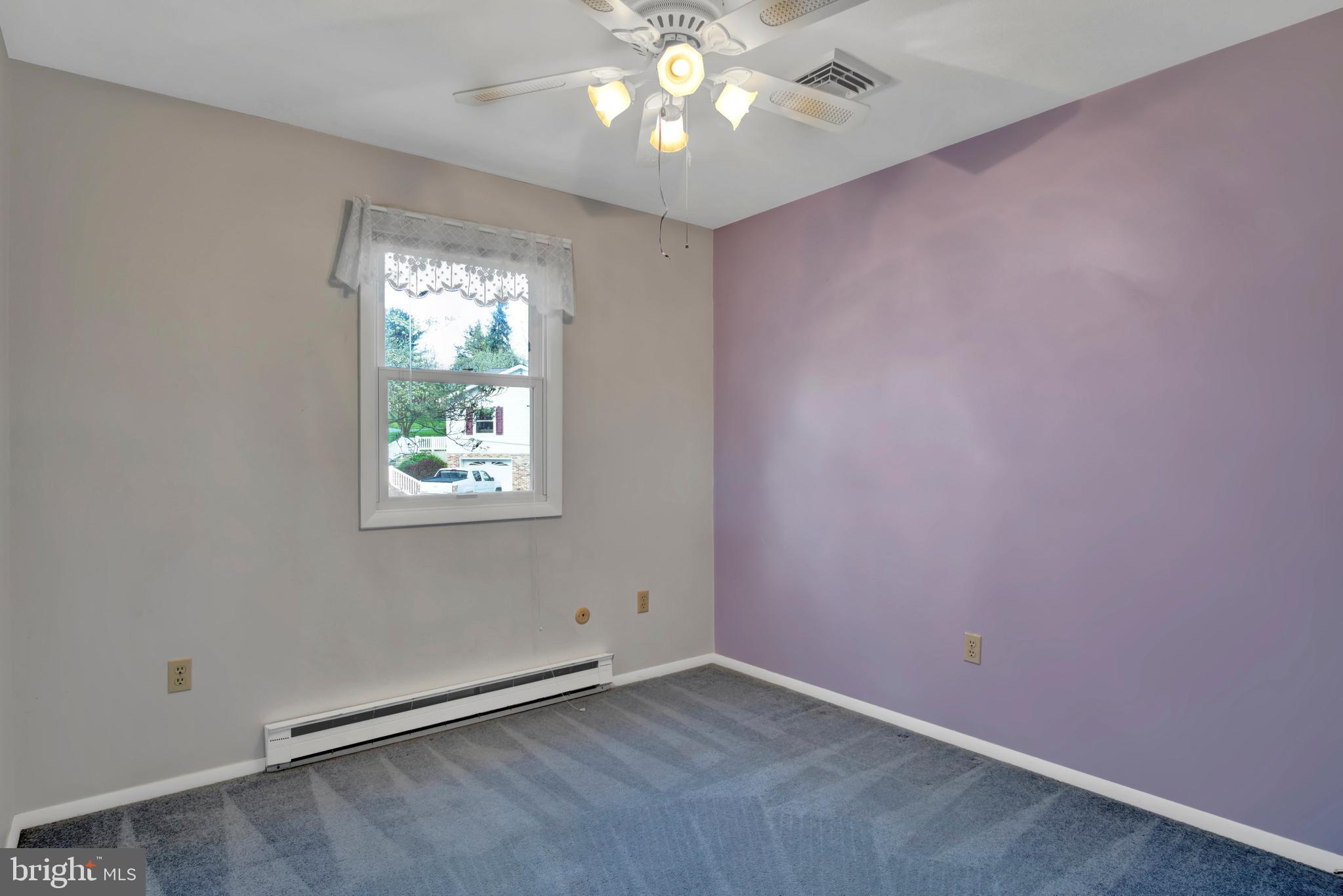 45 Sam Snead Circle Etters, PA 17319 - Photo 18 of 34 an empty room with a chandelier fan and windows
