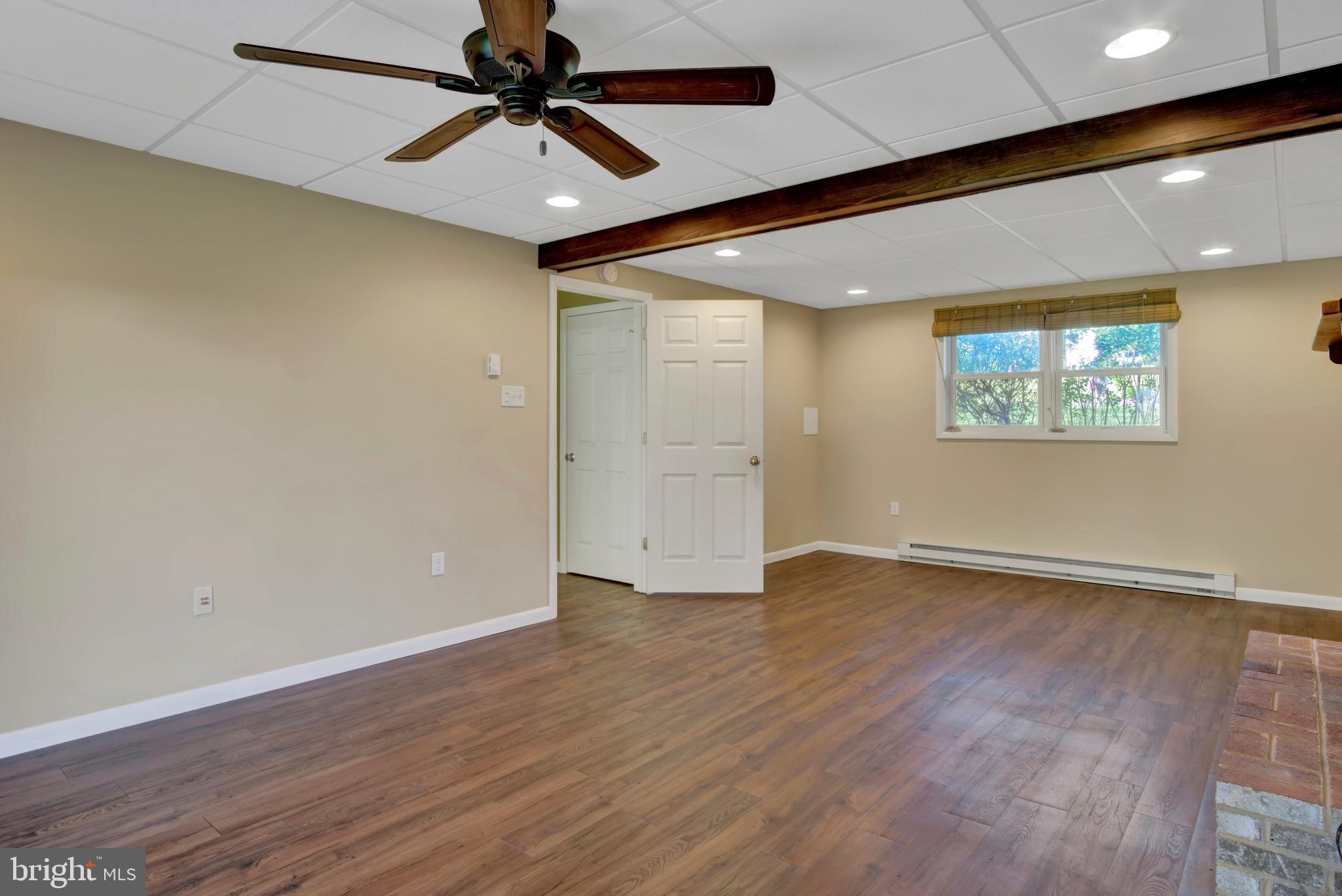 45 Sam Snead Circle Etters, PA 17319 - Photo 20 of 34 an empty room with wooden floor chandelier fan and windows