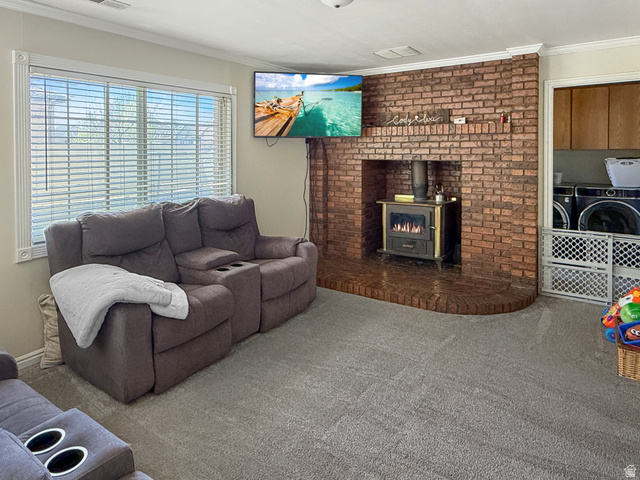 1716 Sagewood Road Price, UT 84501 - Photo 18 of 73 Living area featuring crown molding, carpet, and a wood stove