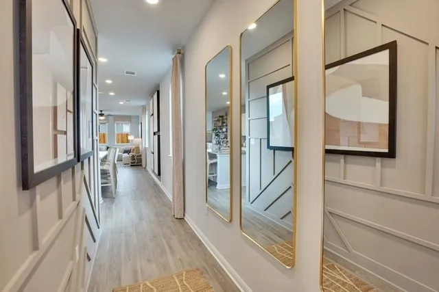 a view of a hallway view with wooden floor and staircase