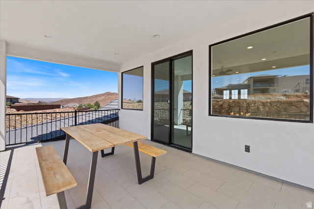 1192 East Corral Way Washington, UT 84780 - Photo 44 of 81 Covered outdoor patio featuring tile flooring and a black metal railing