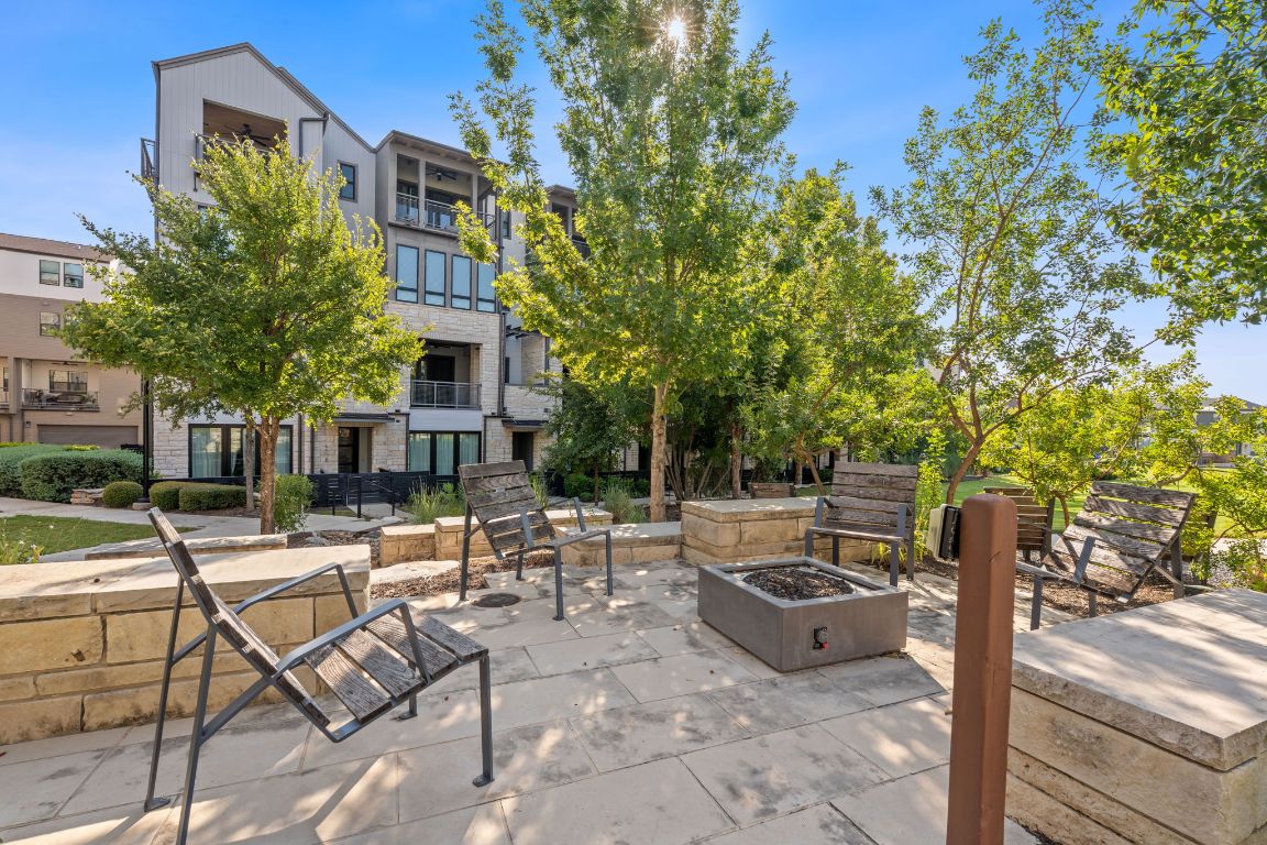 a view of a patio with table and chairs and potted plants