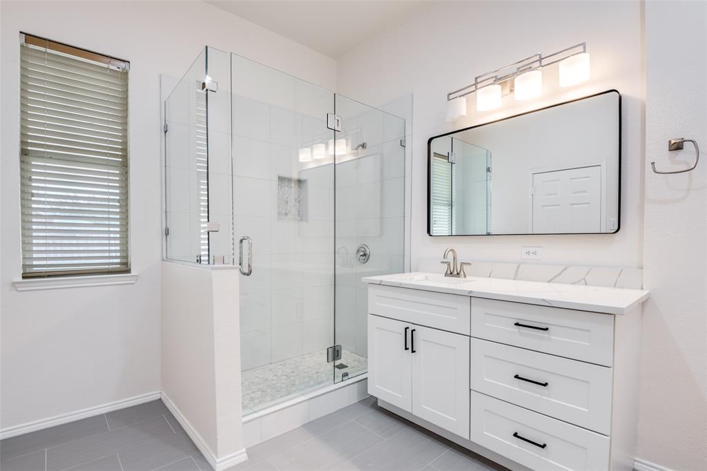 405 Hackberry Drive Fate, TX 75087 - Photo 15 of 24 a bathroom with a double vanity sink mirror and