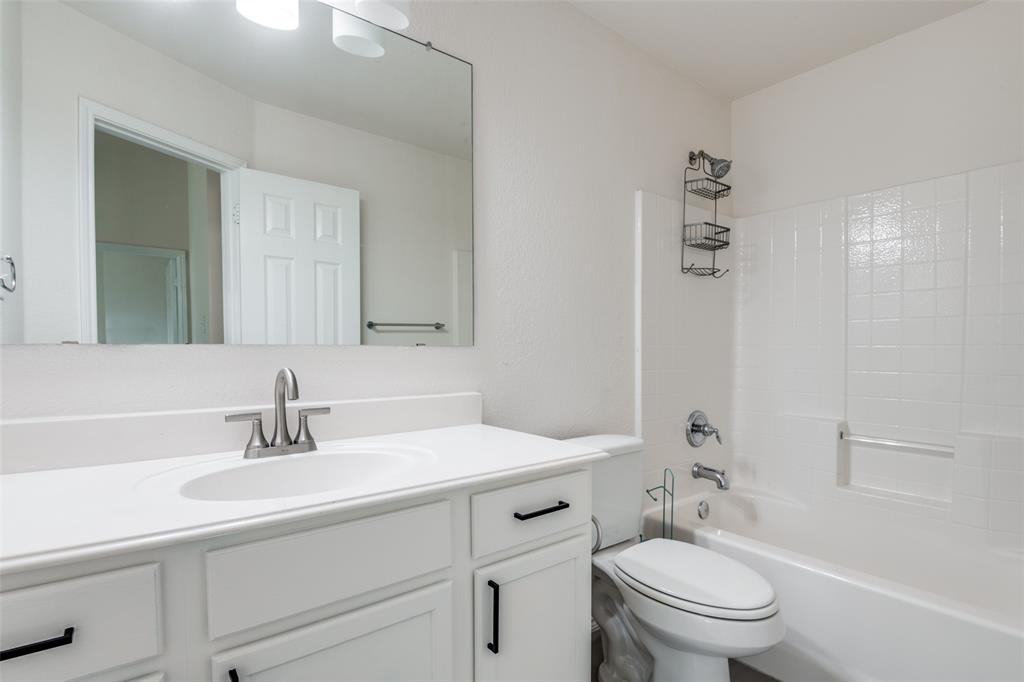 405 Hackberry Drive Fate, TX 75087 - Photo 20 of 24 a bathroom with a sink toilet vanity and shower