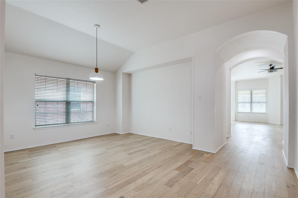 405 Hackberry Drive Fate, TX 75087 - Photo 4 of 24 a view of an empty room with wooden floor and a window