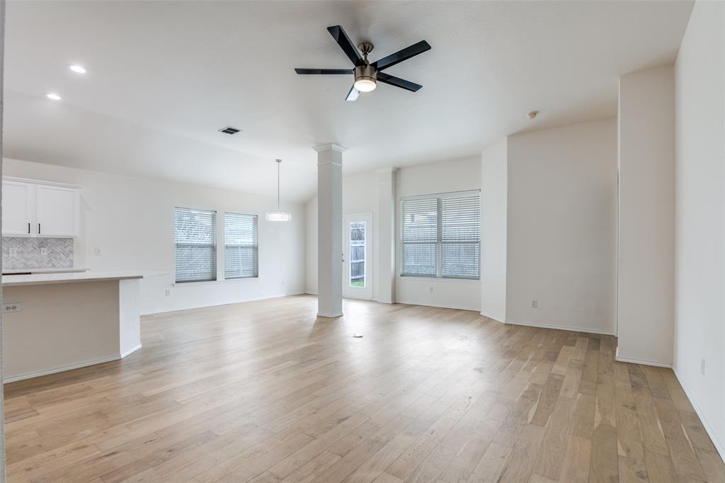 405 Hackberry Drive Fate, TX 75087 - Photo 5 of 24 a view of an empty room with a kitchen and a window