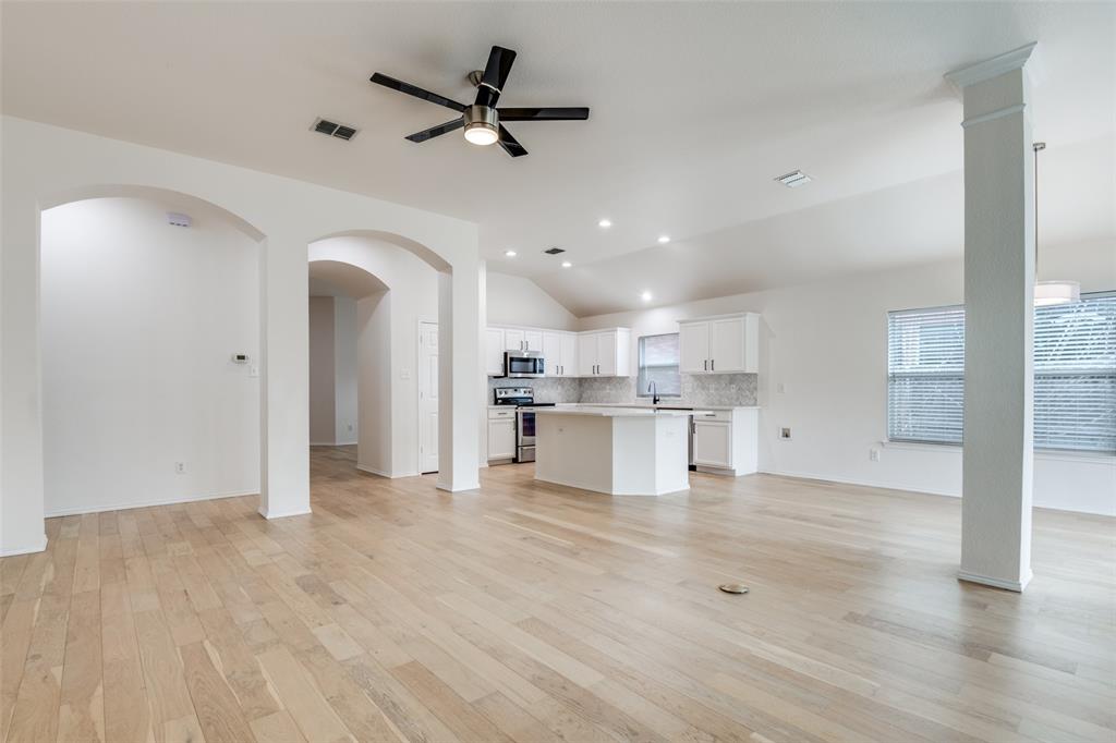 405 Hackberry Drive Fate, TX 75087 - Photo 6 of 24 a view of a kitchen with kitchen island a sink stainless steel appliances and cabinets