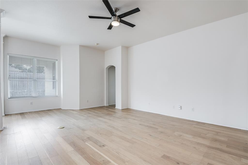 405 Hackberry Drive Fate, TX 75087 - Photo 9 of 24 an empty room with wooden floor and windows