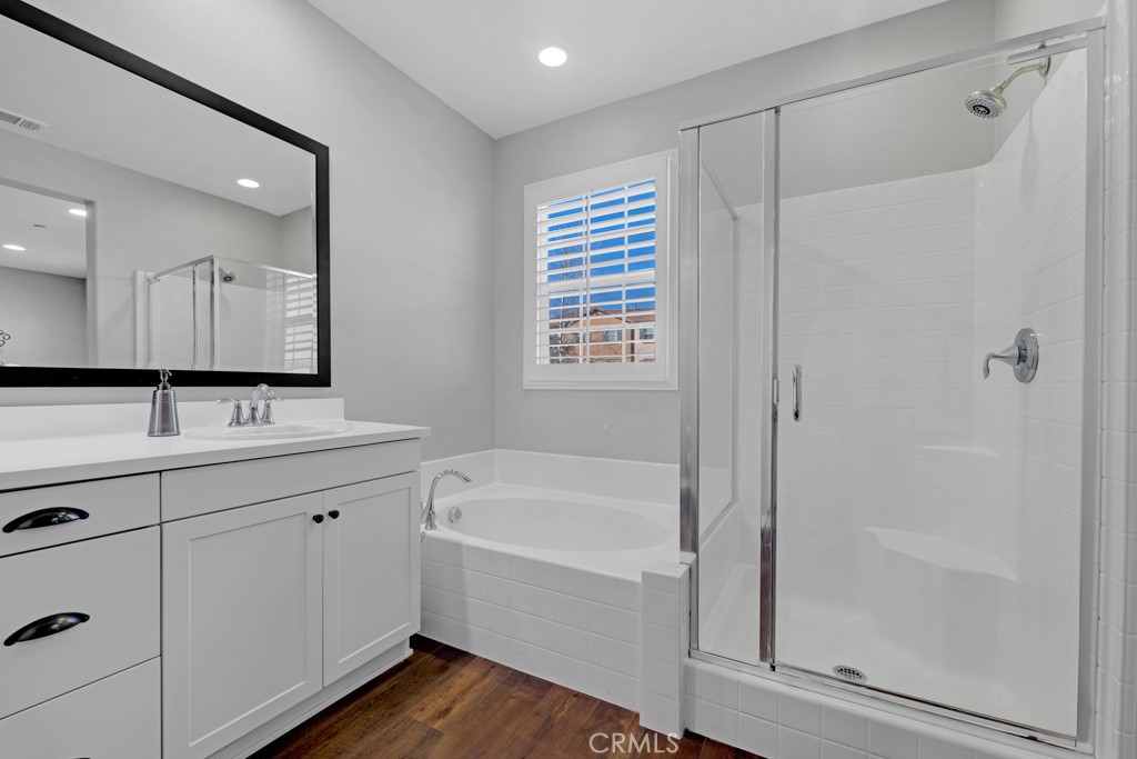 22104 Barrington Way Saugus, CA 91350 - Photo 16 of 31 a bathroom with a tub sink and mirror