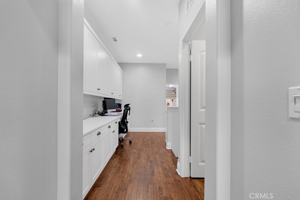 22104 Barrington Way Saugus, CA 91350 - Photo 17 of 31 a view of a kitchen with wooden floor and electronic appliances