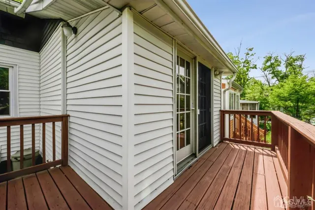 a view of a balcony with wooden floor and fence