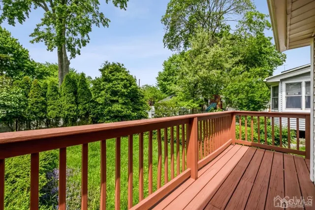 a view of balcony with wooden floor and fence