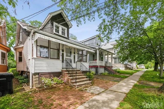 a front view of a house with a garden