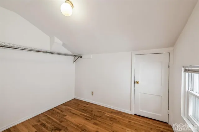 a view of a room with wooden floor and white walls