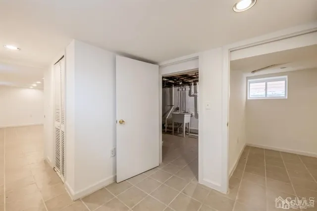 a view of a hallway with closet and a livingroom view