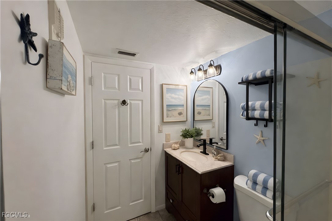 1211 Barrett Road, Unit 1106 North Fort Myers, FL 33903 - Photo 11 of 28 a bathroom with a sink vanity and mirror